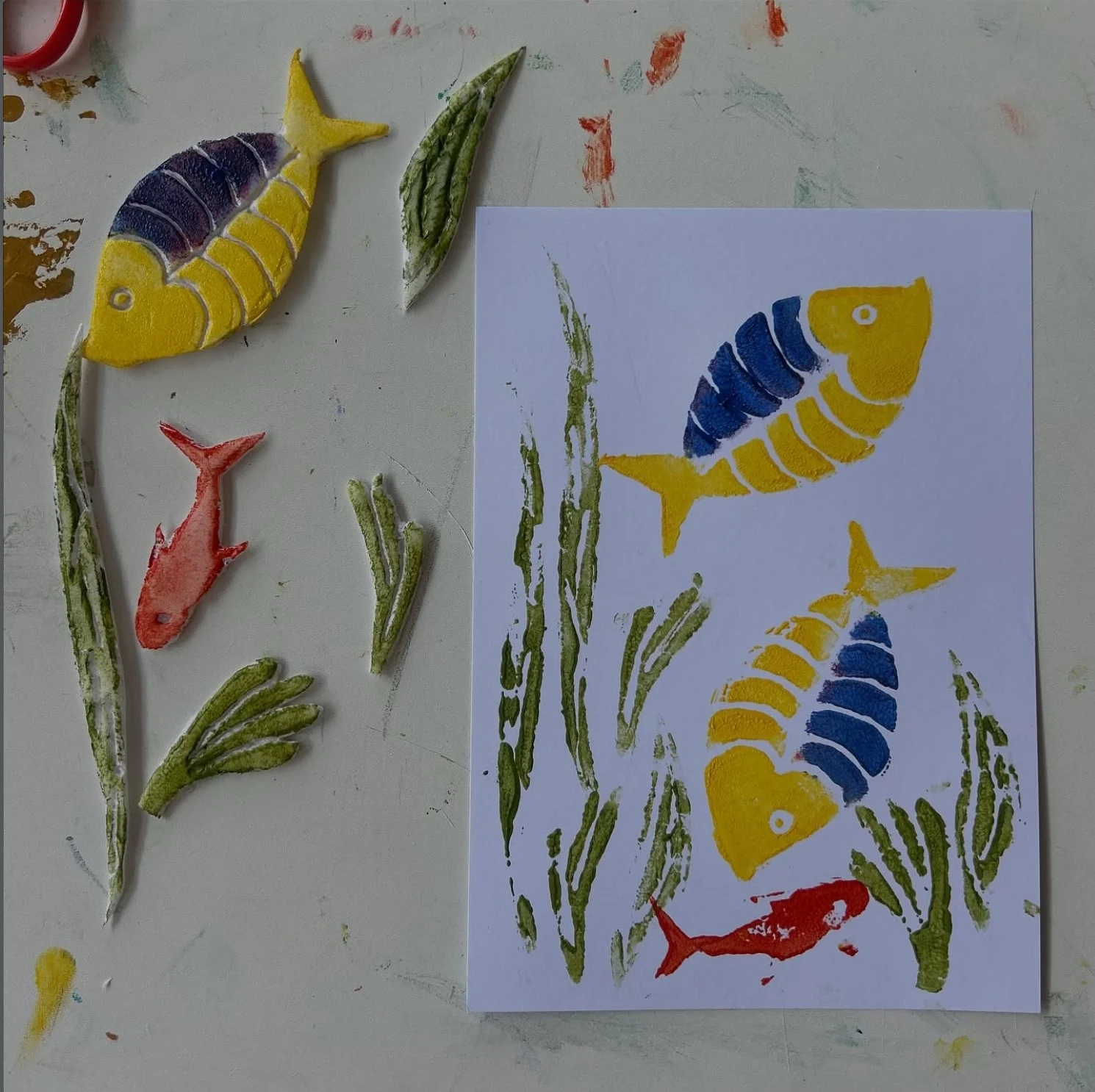 Colourful handmade fish and seaweed prints with printing blocks