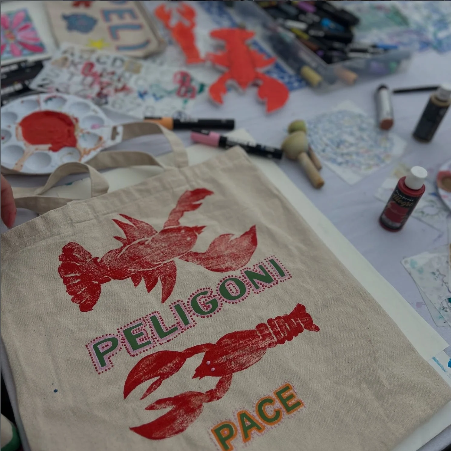 A red lobster printed by hand onto a Peligoni tote bag